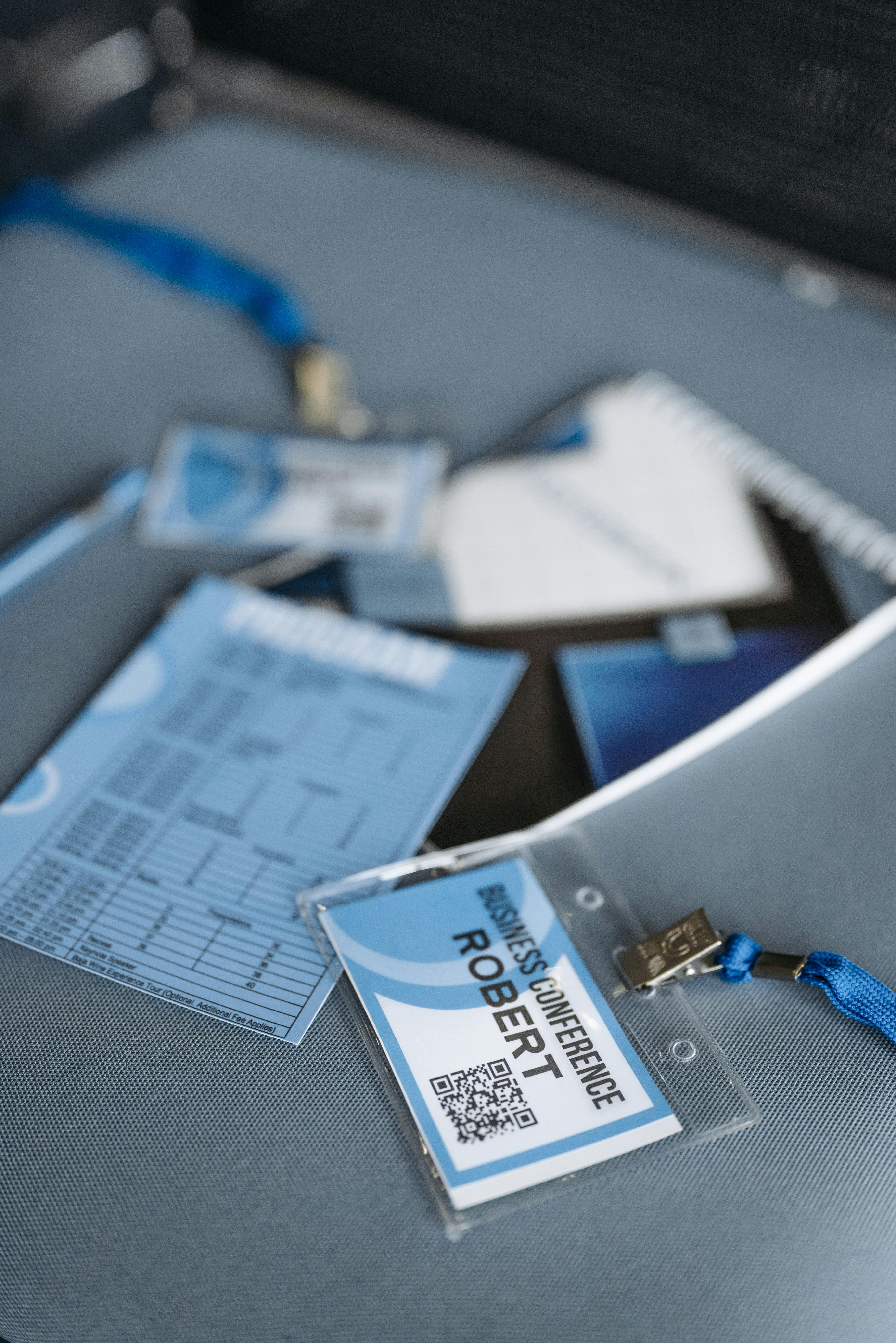 Close-up of business conference name tags and event materials lying on a table.